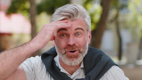Surprised Man Reacts to Good News Outdoors