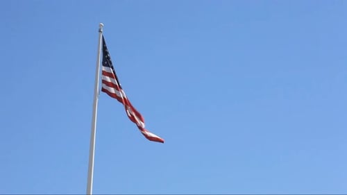 American Flag Waving Against Clear Blue Sky