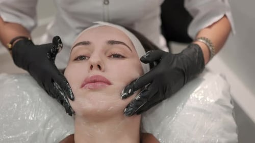 Woman Receiving Facial Treatment at Spa