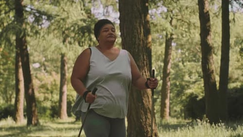 Mature Black Woman Nordic Walking in Park