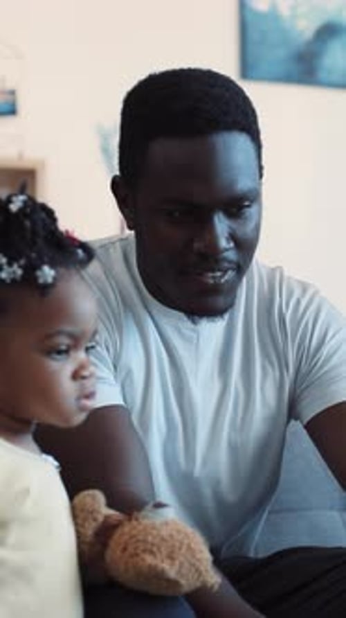 Man and Child Relaxing Together Indoors