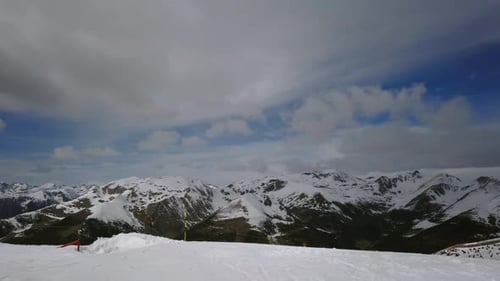 Snowy Mountains Under Cloudy Sky in Winter