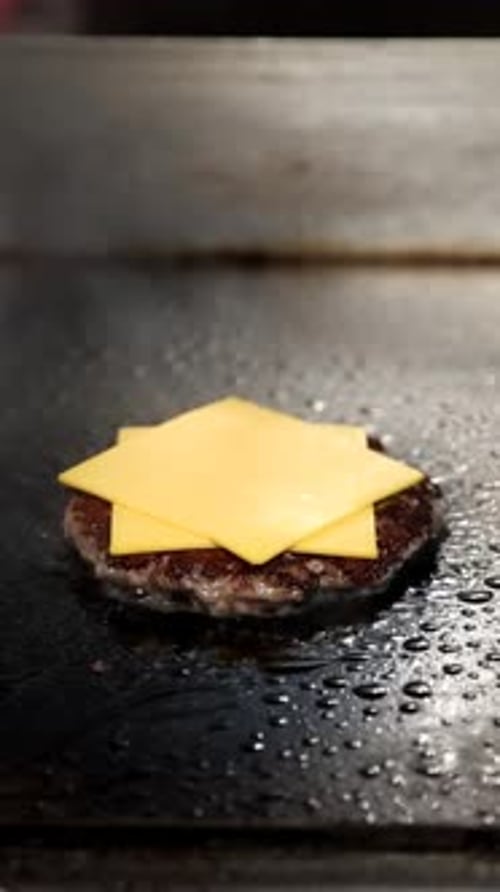 Burger Being Prepared on Flat Top Grill