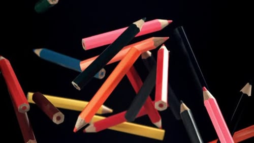 Multicolored Pencils Fly and Fall on a Black Background Filmed on a Highspeed Camera at 1000 Fps