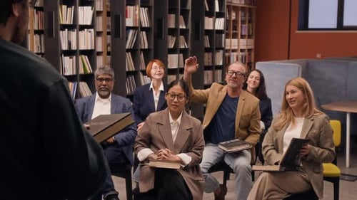 Diverse Adults Attending a Book Club in a Library