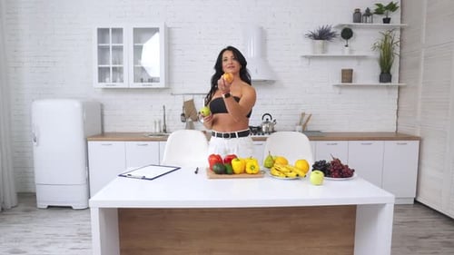 Healthy Woman with Fruit in Modern Kitchen