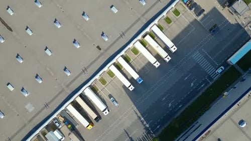 Aerial Top Down View of Cargo Trucks at Logistics Center