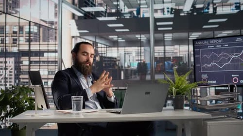 Business Man Sitting at Desk in Modern Office