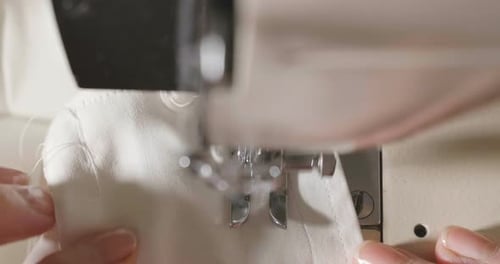 Close Up of Sewing Machine Stitching White Fabric