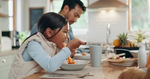 Girl Enjoys Spaghetti Dinner with Family at Home