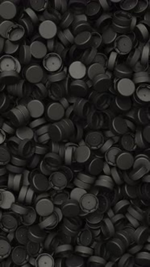 Pan Across a Pile of Black Plastic Bottle Caps for Recycling and Plastic Industry Production 3D