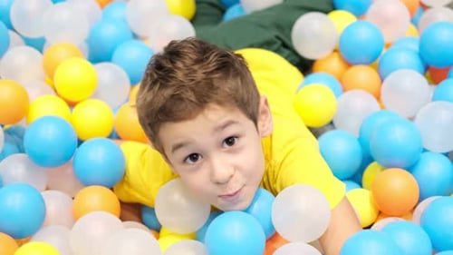 Boy Playing in Playground Colourful Ball Pool