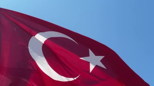 Waving Turkish Flag Against Blue Sky