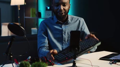 Man Reviewing Keyboard in Dark Room Podcast