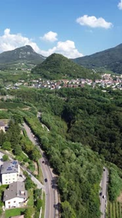 Aerial view of village in green hills and mountains, Italy.