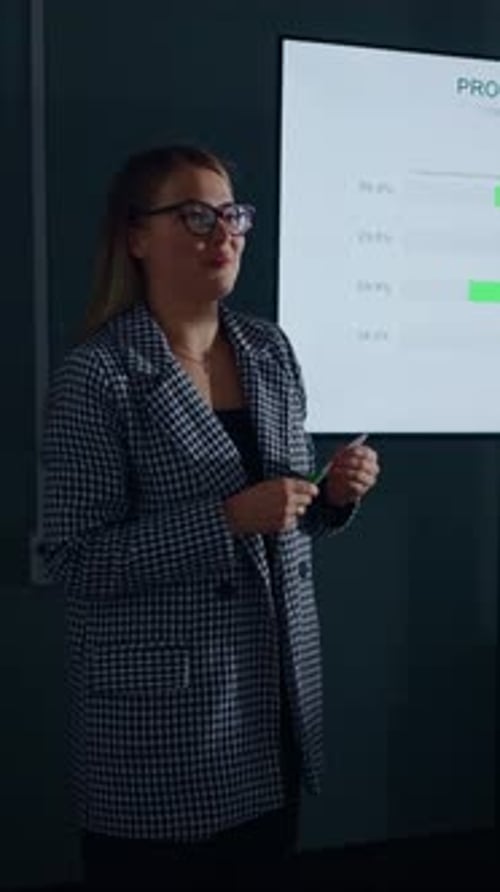 Young Woman Giving Presentation On Screen in Office
