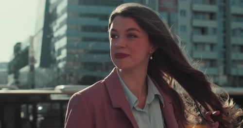 Smiling Woman with Long Hair in Urban Setting