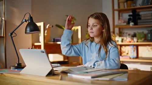 Girl Studies at Desk Using Tablet in Home