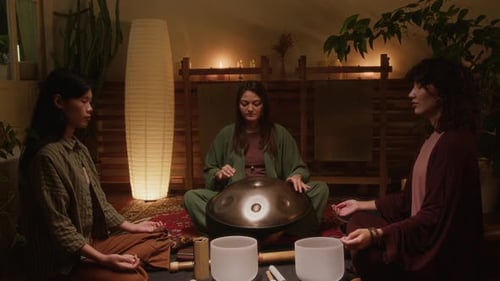 Female Practitioner Playing Hang Drum for Guests during Sound Meditation