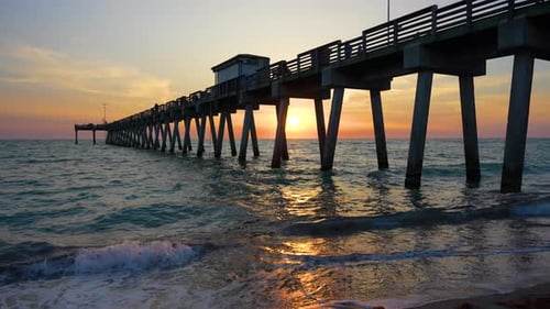 Sunset Landscape at Venice Fishing Pier in Florida Ocean Surf Waves Crashing on Sandy Beach Covered