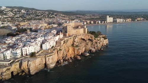 Peniscola village in Spain and the castle citadel overlooking the Mediterranean Sea - pull back aeri