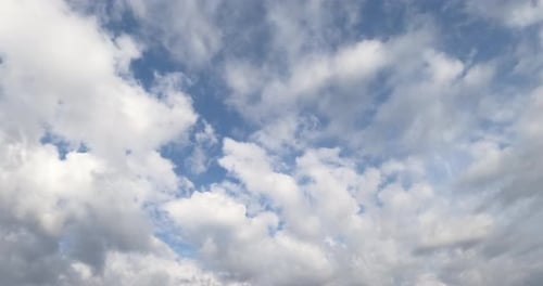 White soft cloudscape accumulating in the atmosphere. Rainy clouds gathering in the sky. Timelapse.