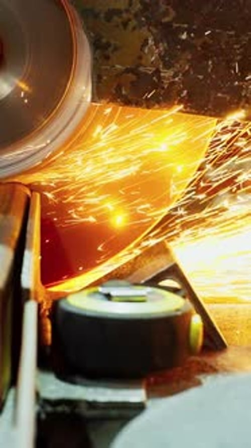 Worker Using an Angle Grinder Producing a Lot of Sparks