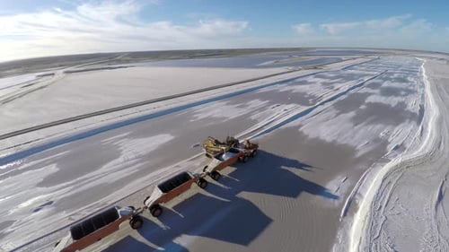 Industrial Harvester Collecting Salt in a Vast Salt Flat