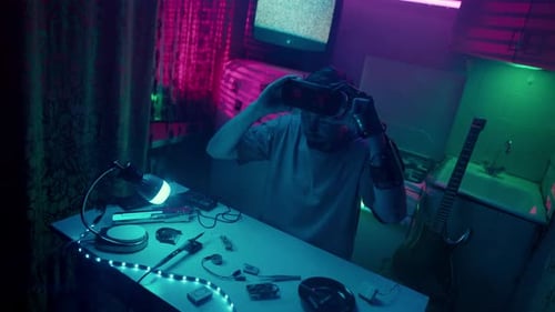 Man Assembling VR Headset in Futuristic Room