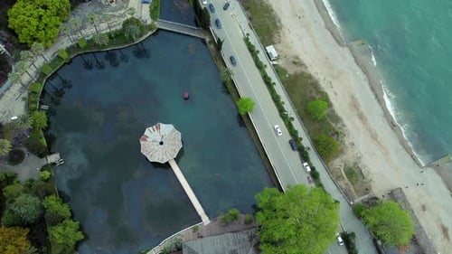 Aerial View of Cars Drive on Road and Waters Outdoors Irrl