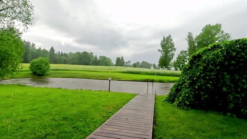 Heavy rain over rural countryside landscape with pathway, static view