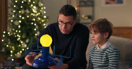 Cheerful Boy Sitting on the Couch with Uncle
