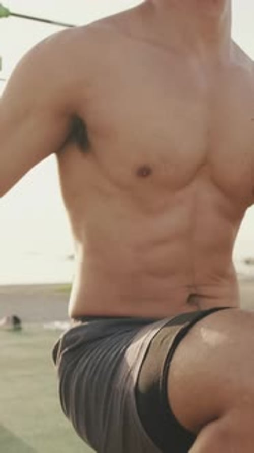 Unrecognizable young man does a warm-up, training the leg muscles, run high raising your knees