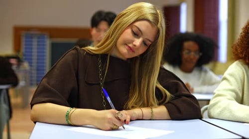 Blonde High School Student Writing an Exam in a Classroom