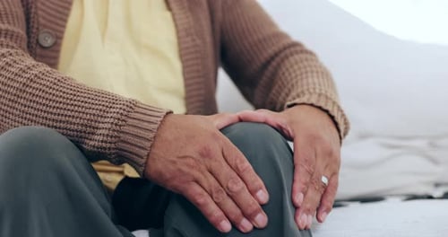 Senior Man Massaging Sore Knee for Relief