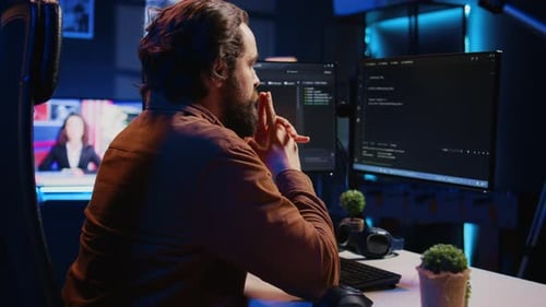 Software Engineer Concerned Concentrating on Finding Code Bugs Close Up