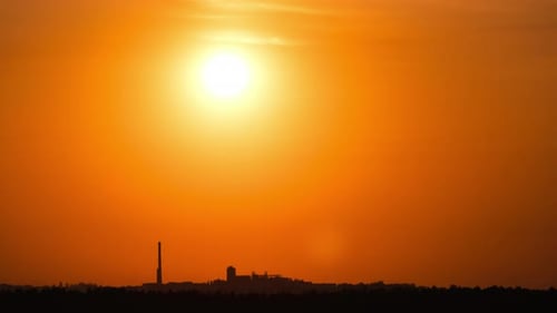 Golden Sunset Time-Lapse Behind City Silhouette