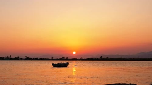 Small Boat at a Beach during Sunset