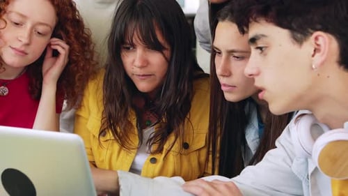 Young College Students Working Together on Laptop at Campus Library