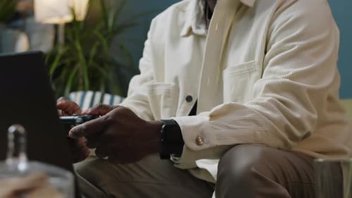 Young Adult Gaming on Laptop with Controller