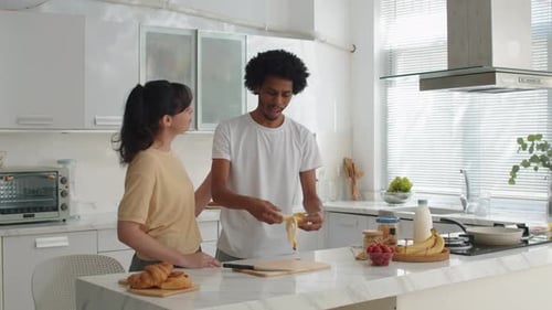 Couple Cutting Bananas and Preparing Breakfast Together