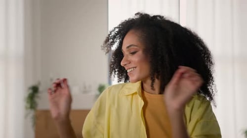 Woman Smiling and Dancing Indoors