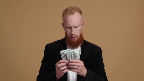 Closeup Shot of a Bearded Guy Counting Money