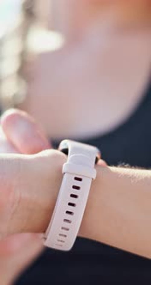 Woman Using Activity Tracker on Wrist Outdoors