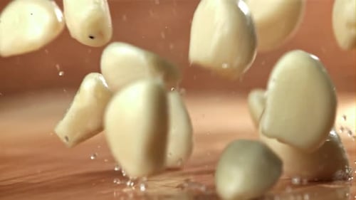 Fresh Garlic Falls on a Wet Cutting Board Filmed on a Highspeed Camera at 1000 Fps