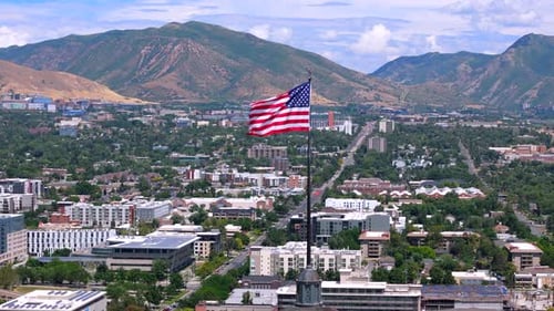 Scenic Skyline With Waving American Flag in Salt Lake City