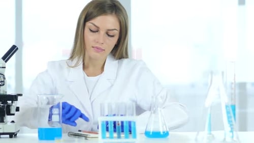 Female Scientist Working with Microscope in a Lab