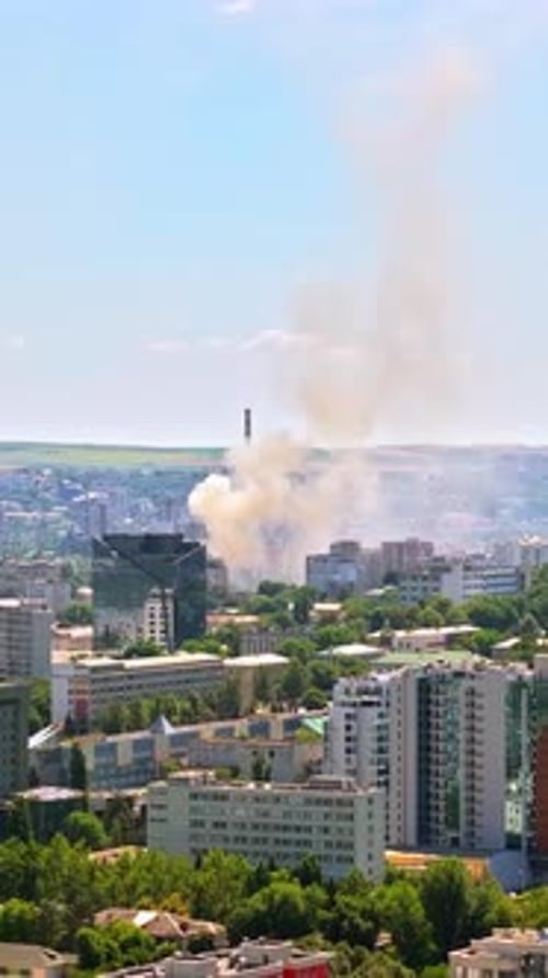 Aerial drone view of smoke coming out of a building in Chisinau, Moldova. Vertical