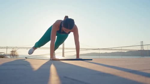 Athletic Woman Performing Mountain Climbers Exercise Outdoors