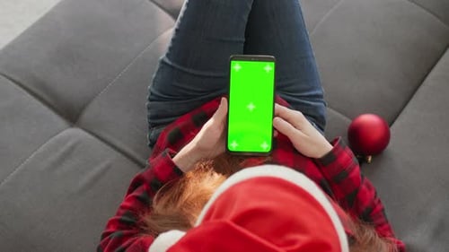 Woman in Santa Hat with Green Screen Phone